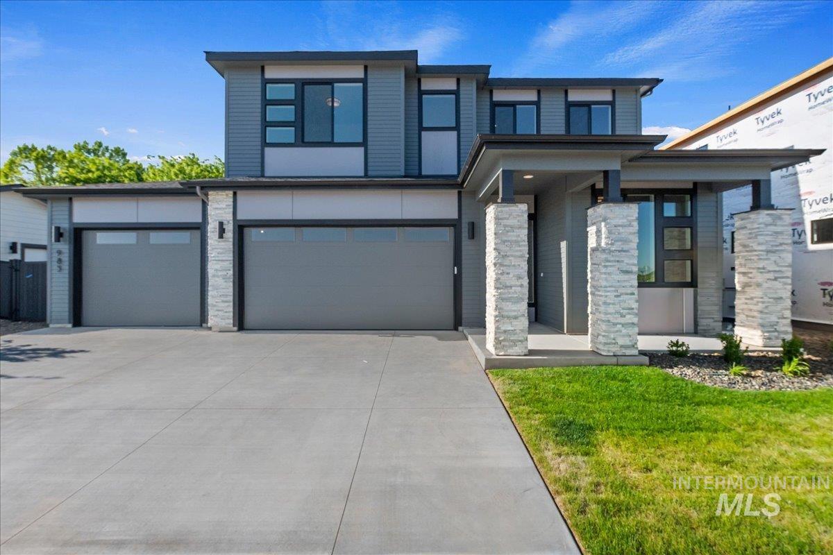 985 West Malbar Street Meridian, ID 83646 - Photo 2 of 39 Modern exterior featuring a prominent two-car garage with frosted glass panels