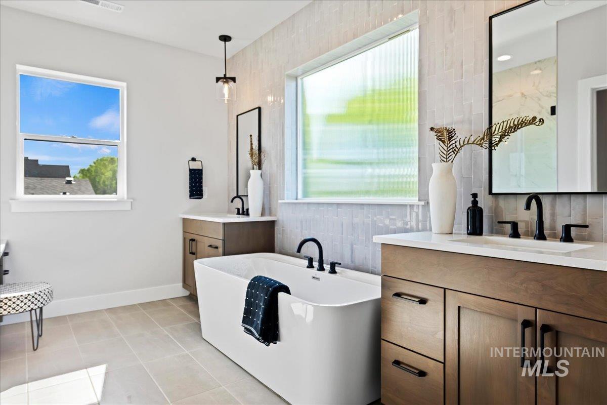985 West Malbar Street Meridian, ID 83646 - Photo 22 of 39 Modern bathroom featuring a freestanding soaking tub with matte black fixtures