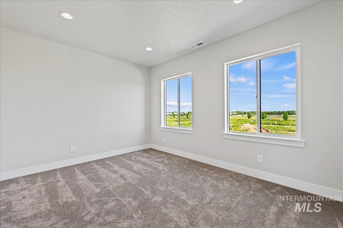 985 West Malbar Street Meridian, ID 83646 - Photo 26 of 39 Carpeted room featuring two large windows, recessed lighting, and white baseboards