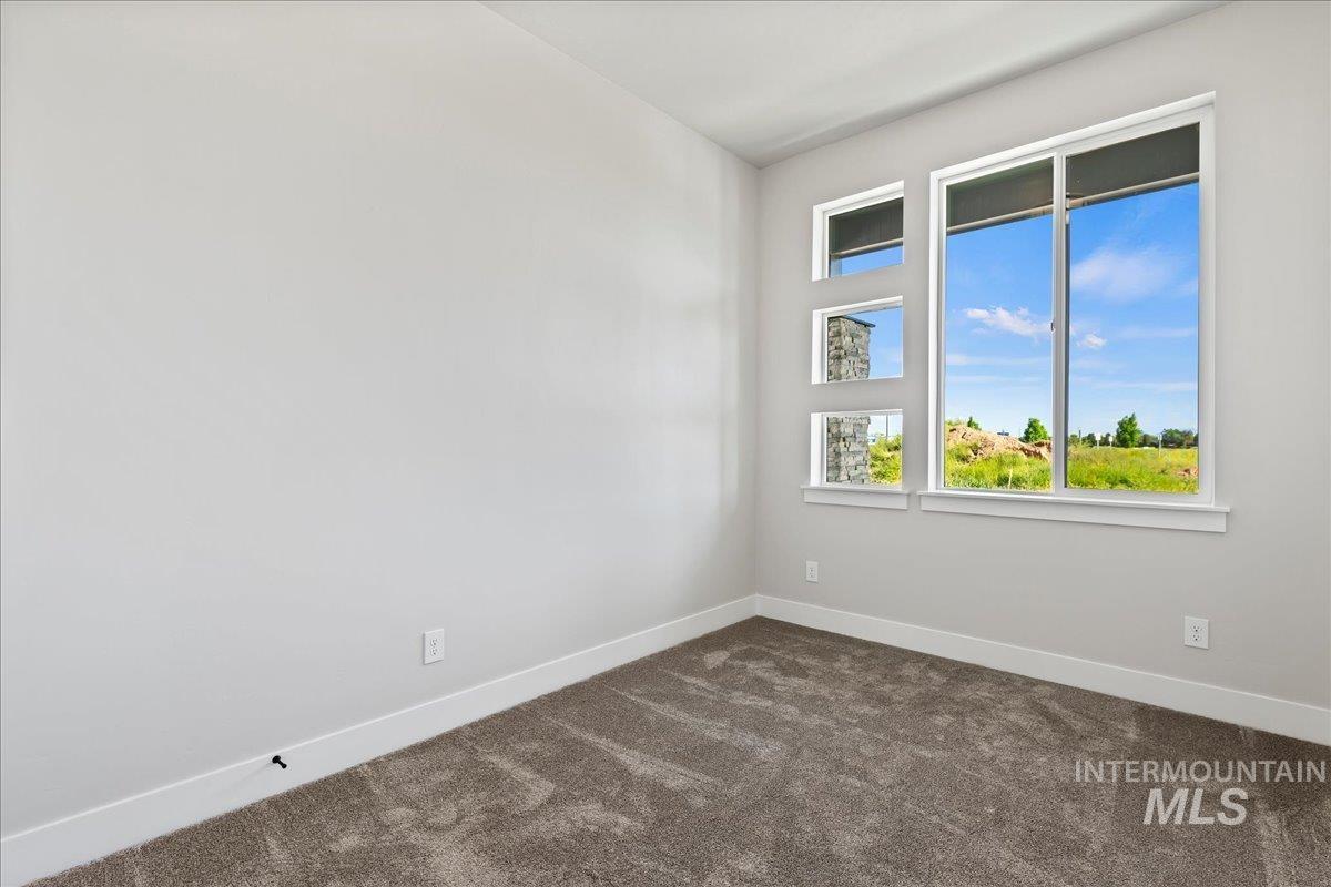985 West Malbar Street Meridian, ID 83646 - Photo 32 of 39 Bright room with multiple windows, including a large main window and three smaller rectangular windows
