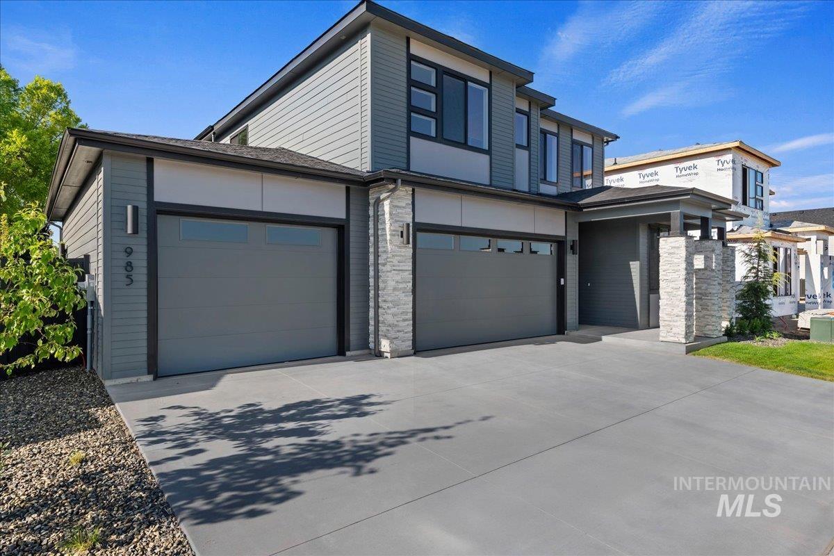 985 West Malbar Street Meridian, ID 83646 - Photo 4 of 39 Modern architectural facade with gray siding and stone accents