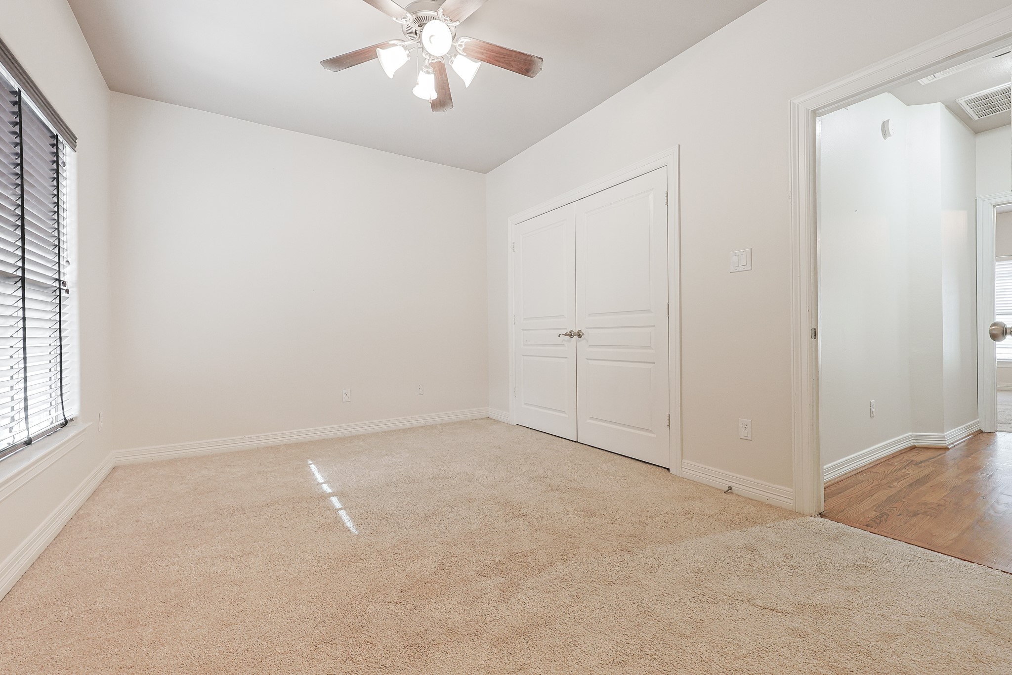 2540 Prospect Street, Unit C Houston, TX 77004 - Photo 27 of 31 an empty room with chandelier fan and windows