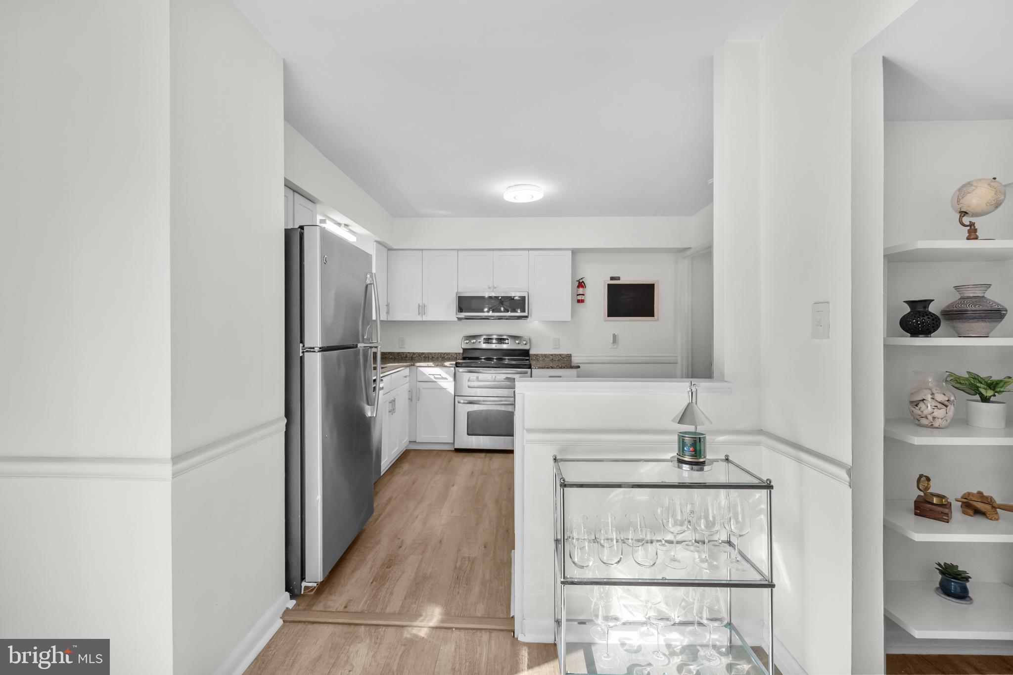 2320 Emerald Heights Court Reston, VA 20191 - Photo 13 of 44 a kitchen with white cabinets and stainless steel appliances