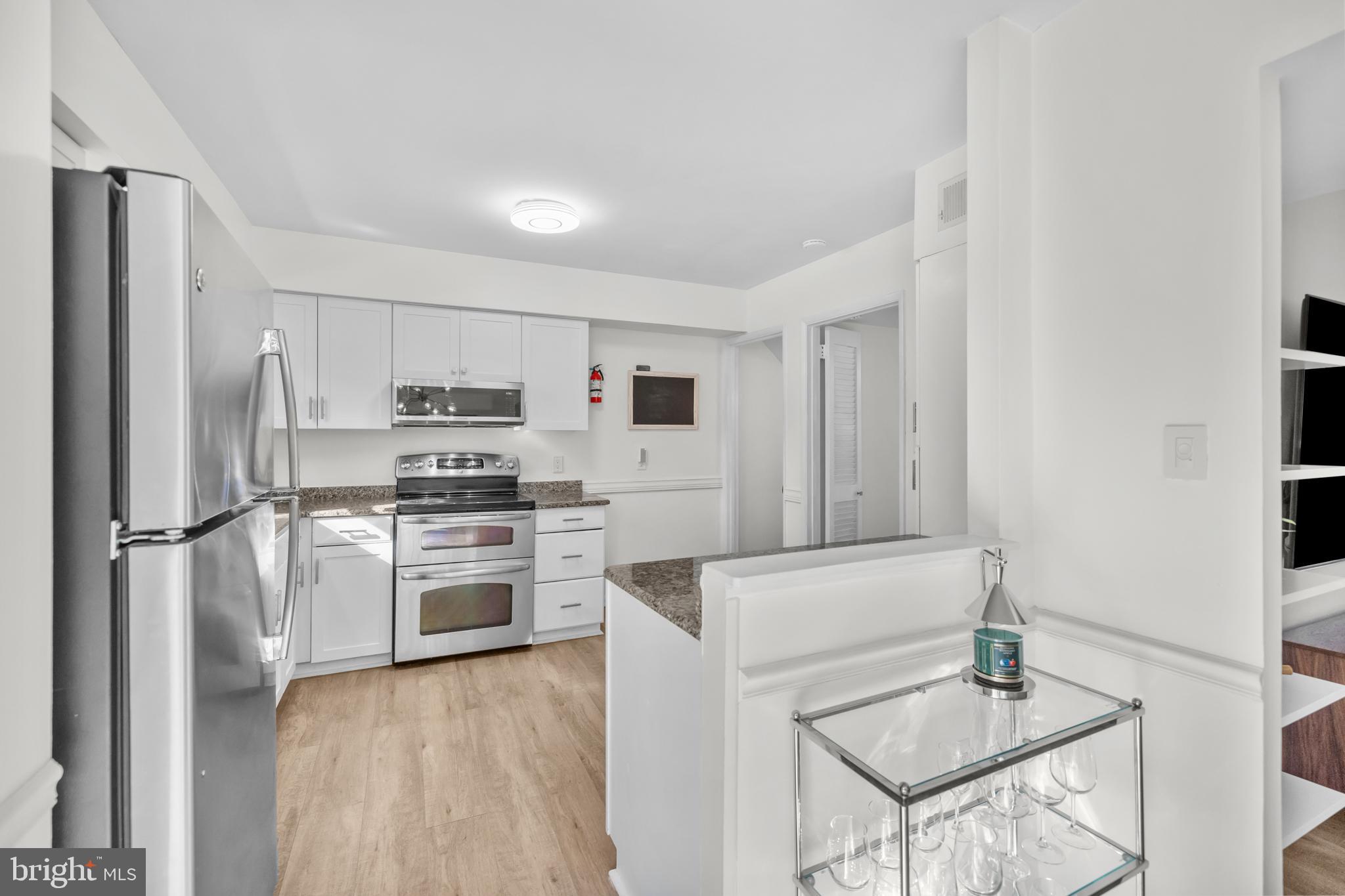 2320 Emerald Heights Court Reston, VA 20191 - Photo 14 of 44 a kitchen with a refrigerator a stove top oven a sink and dishwasher