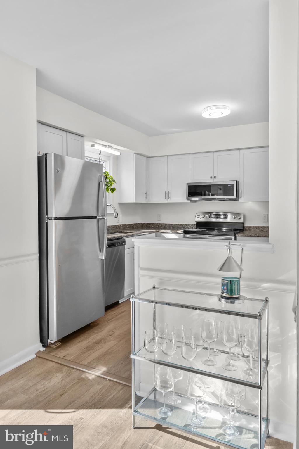 2320 Emerald Heights Court Reston, VA 20191 - Photo 15 of 44 a kitchen with stainless steel appliances granite countertop a refrigerator sink and stove