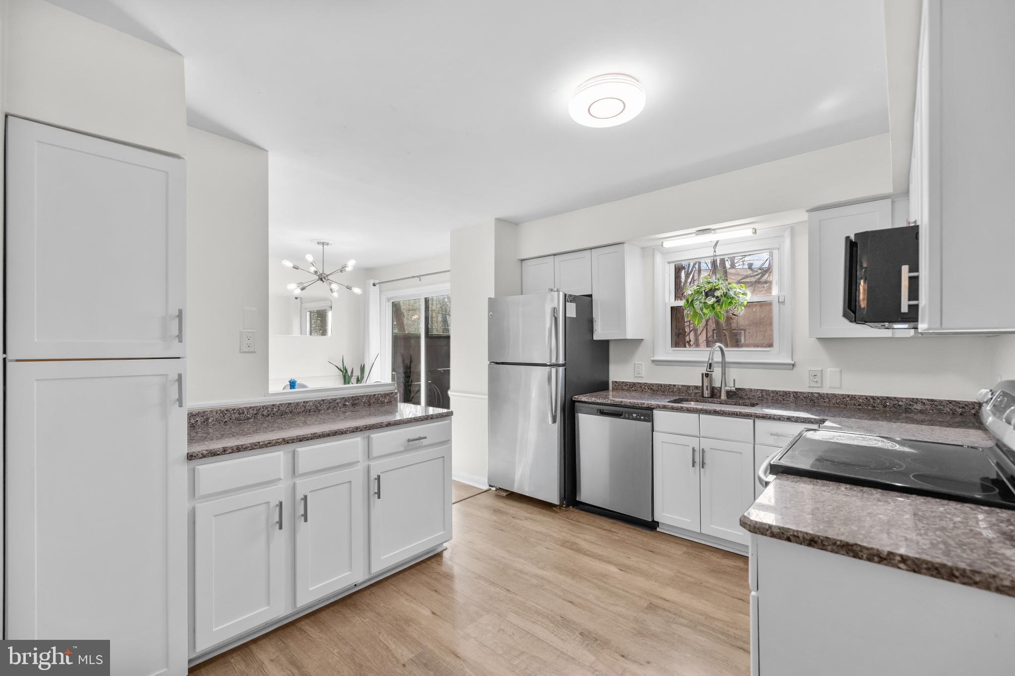 2320 Emerald Heights Court Reston, VA 20191 - Photo 19 of 44 a kitchen with white cabinets and stainless steel appliances