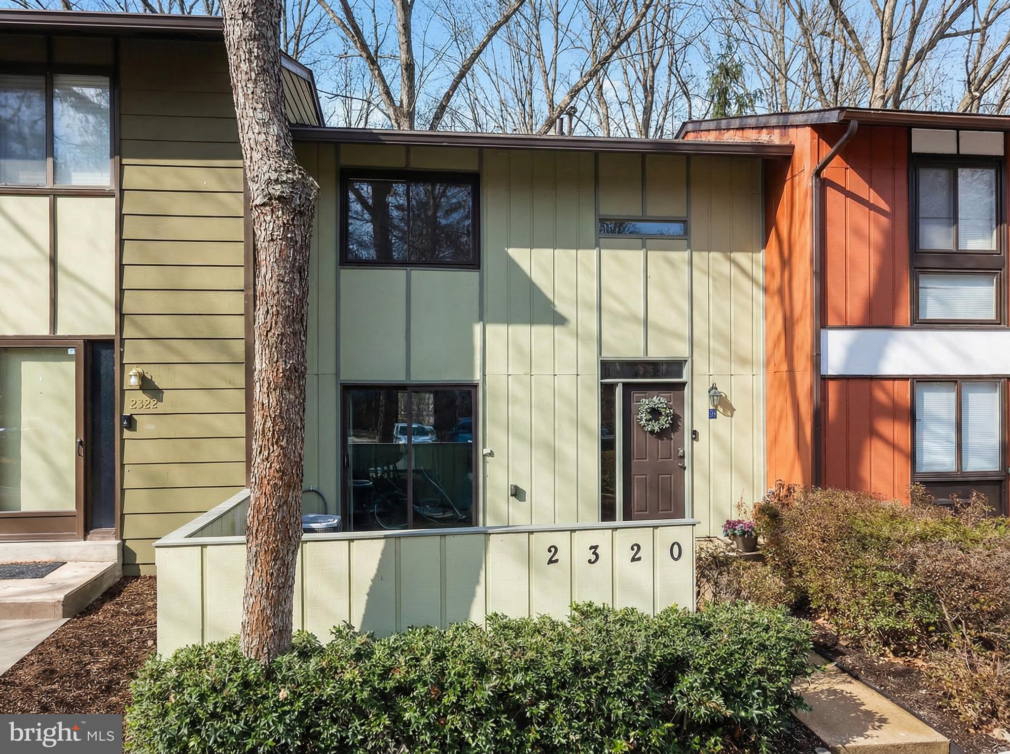 2320 Emerald Heights Court Reston, VA 20191 - Photo 2 of 44 a view of a house with a large window and potted plants