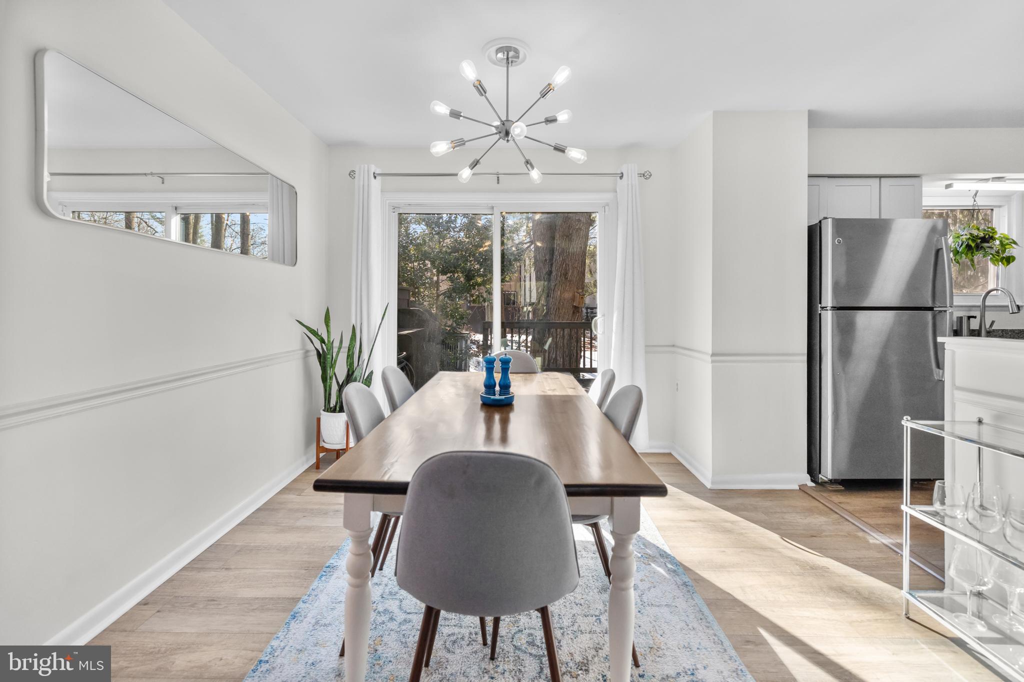 2320 Emerald Heights Court Reston, VA 20191 - Photo 5 of 44 a view of a dining room with furniture a chandelier and wooden floor