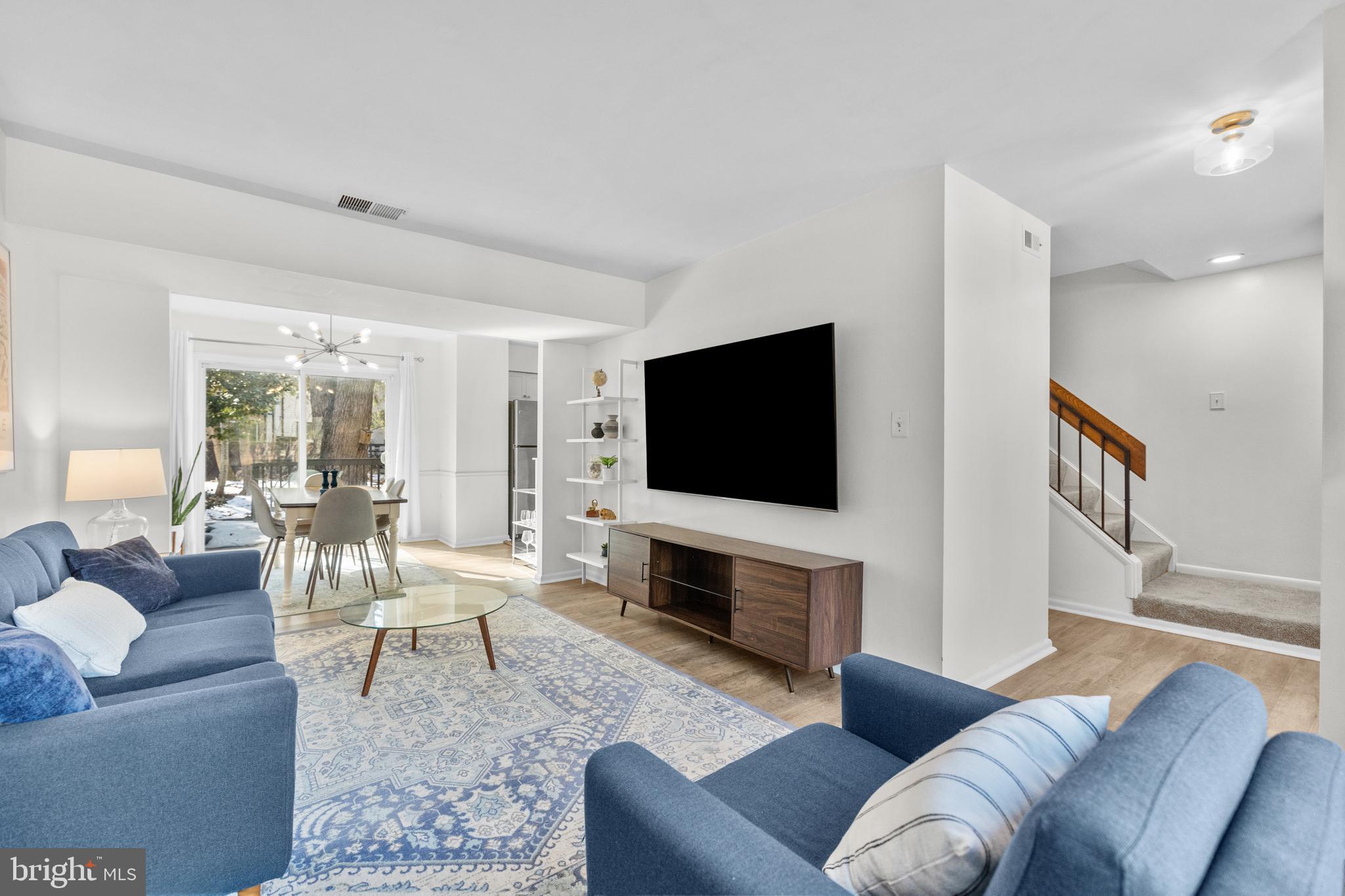 2320 Emerald Heights Court Reston, VA 20191 - Photo 7 of 44 a living room with furniture a flat screen tv and a fireplace