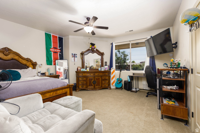 2005 West 450 S Circle St. George, UT 84770 - Photo 30 of 57 Carpeted room featuring a ceiling fan, a window with blinds, and built-in wall shelving