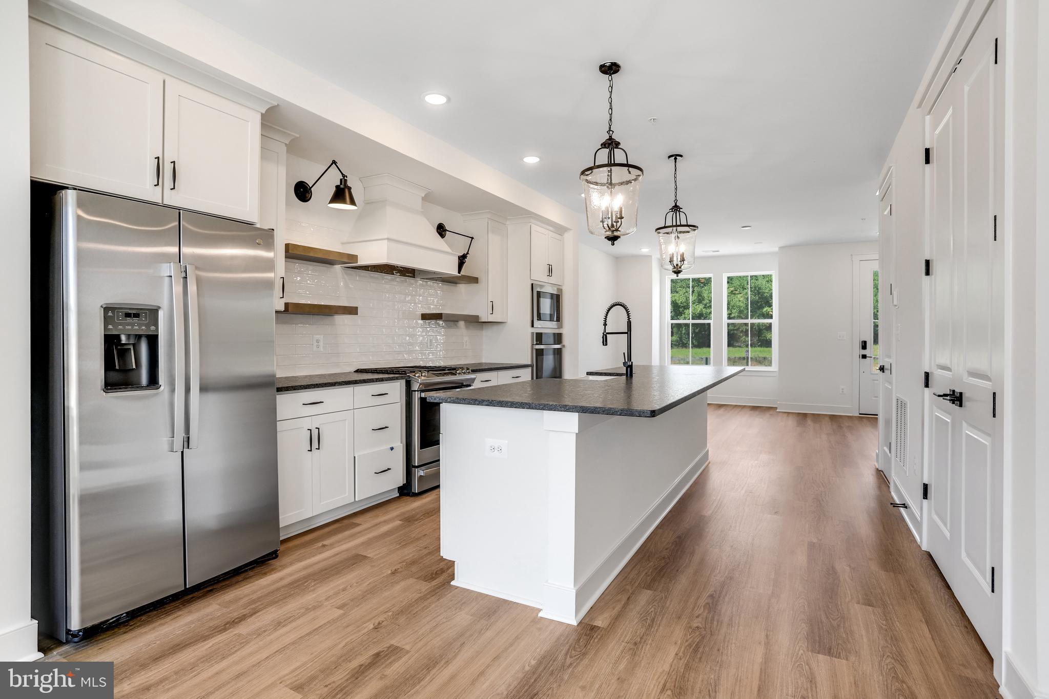 757 Elevation Road Frederick, MD 21702 - Photo 5 of 35 a kitchen with stainless steel appliances a refrigerator sink and cabinets