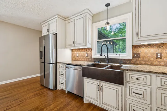 a utility room with sink dryer and washer