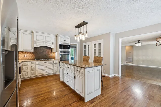 a view of an empty room with window and fireplace