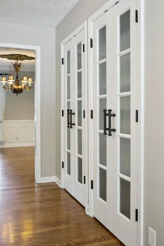 an empty room with wooden floor and fireplace