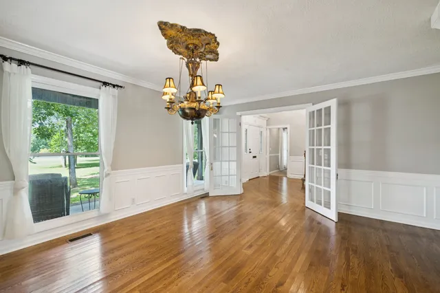 a kitchen with stainless steel appliances granite countertop wooden floor window and cabinets