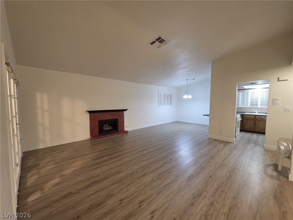 3317 Racquet Street Las Vegas, NV 89121 - Photo 17 of 23 This inviting living space features an elegant fireplace, durable flooring, and a seamless transition to the kitchen.