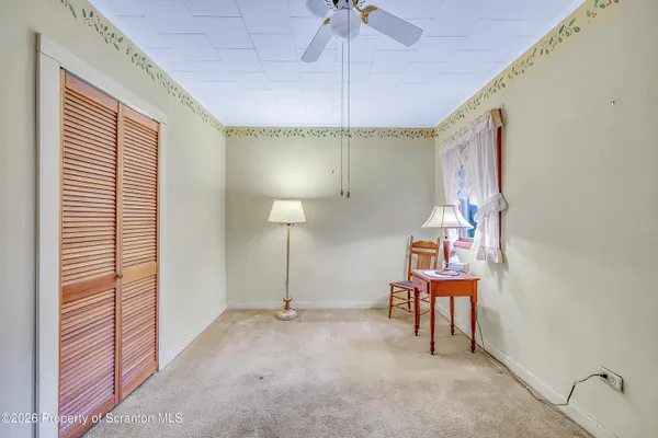 a bed sitting in a bedroom next to a bathroom sink and a mirror