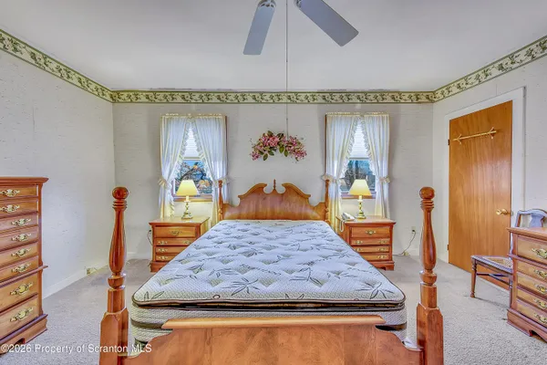 a bedroom with furniture and large window