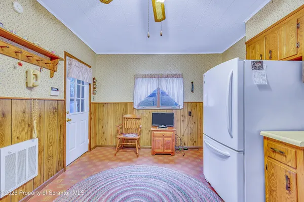 a bed room with a bed and a refrigerator