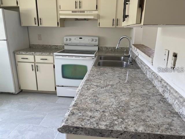 3145 Huron Avenue, Unit A Oldsmar, FL 34677 - Photo 7 of 10 a kitchen with a stove a sink and a refrigerator