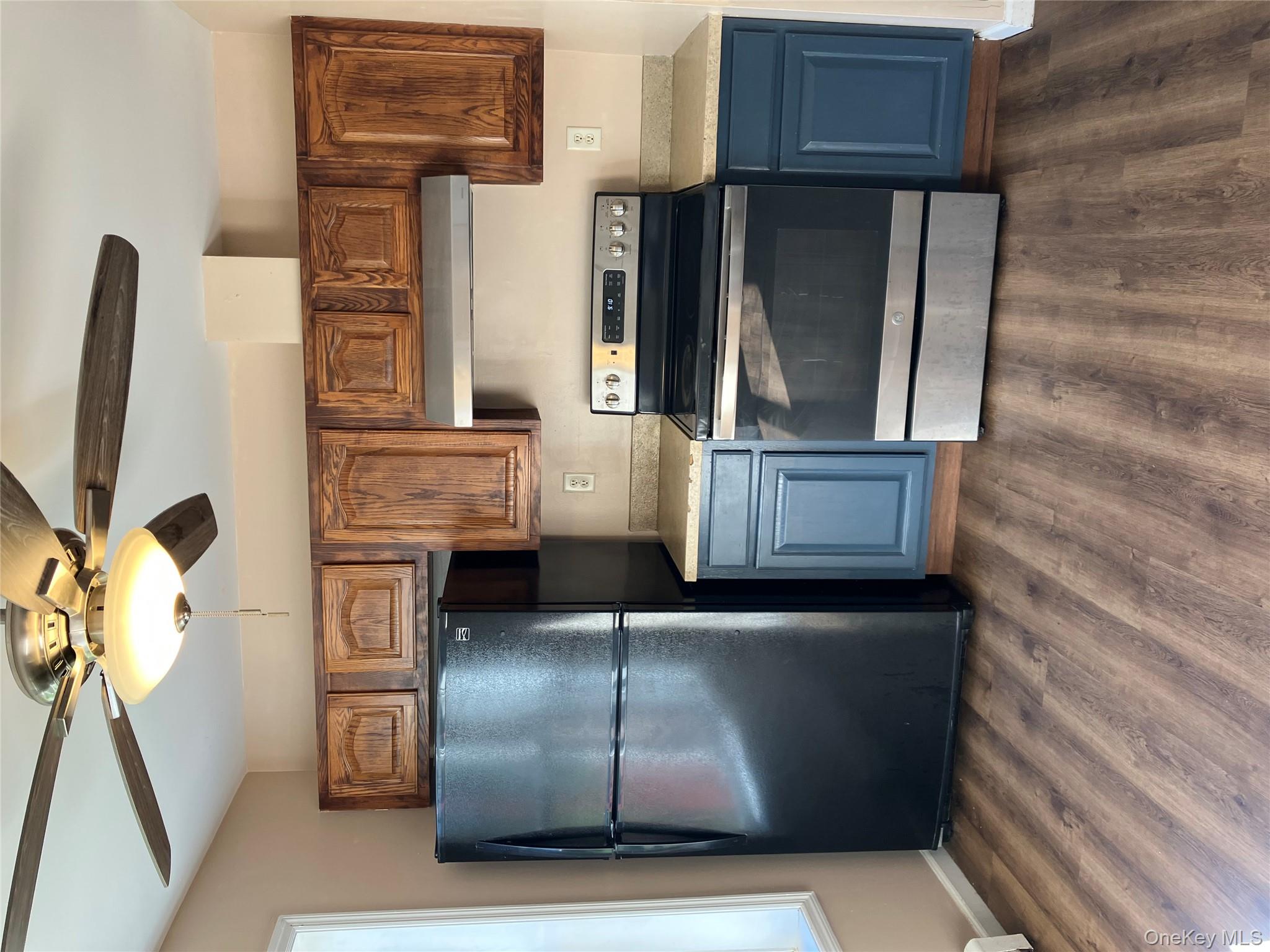133 Ridgebury Road New Hampton, NY 10958 - Photo 2 of 14 Kitchen with black stove, fridge, ceiling fan, and dark wood-style flooring
