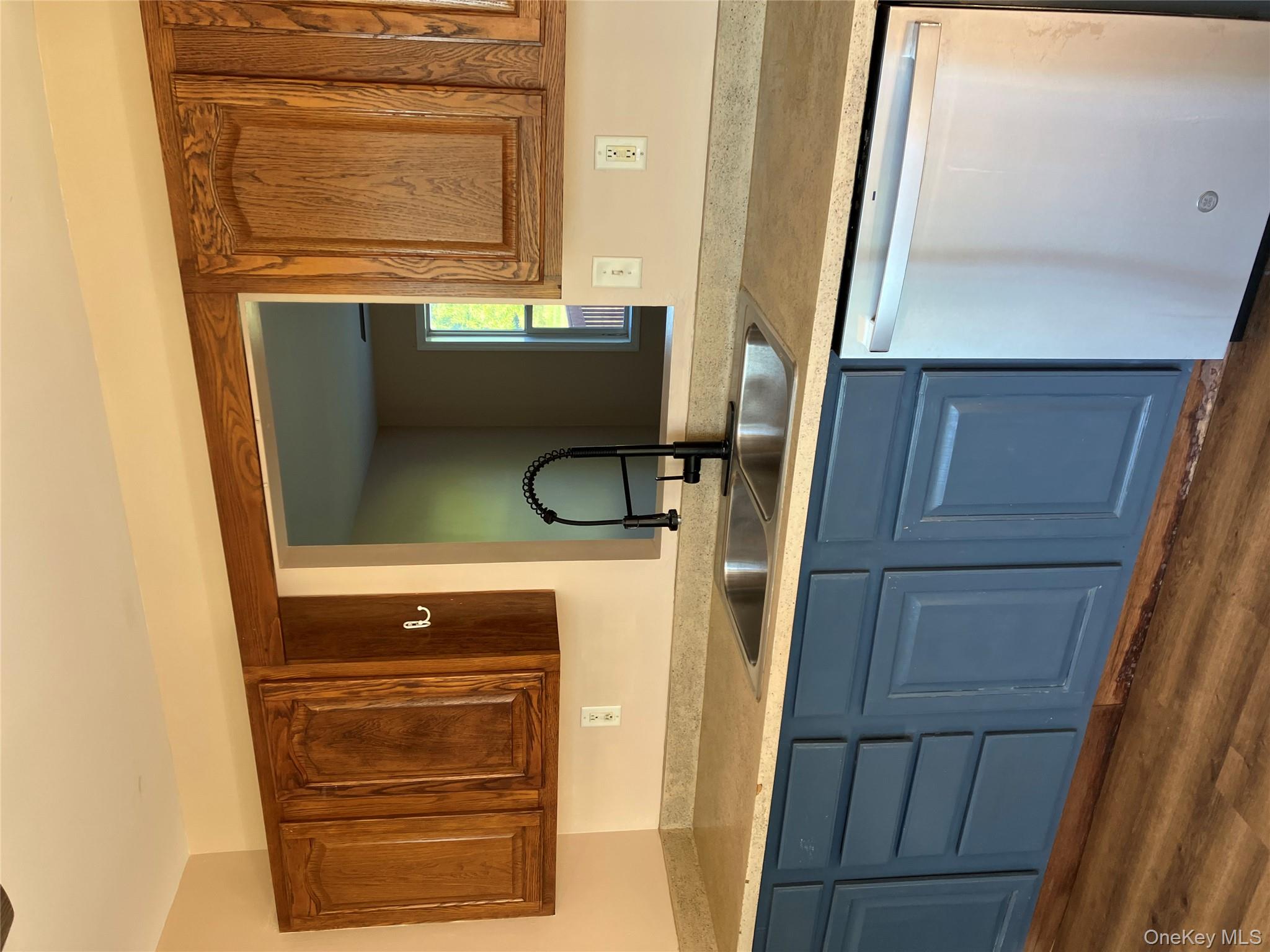 133 Ridgebury Road New Hampton, NY 10958 - Photo 3 of 14 Kitchen with dishwashing machine, light countertops, dark wood-type flooring, and blue cabinets