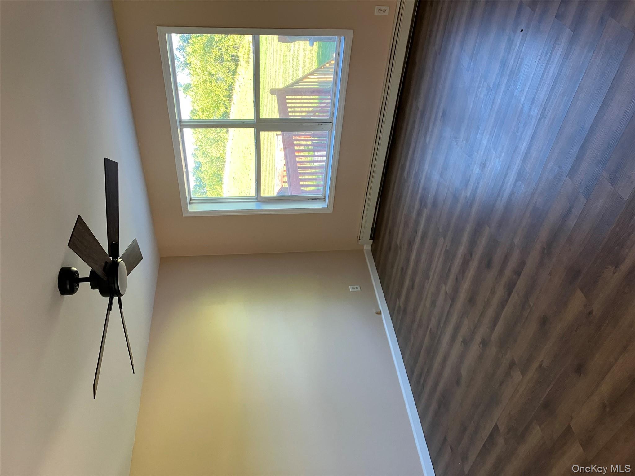 133 Ridgebury Road New Hampton, NY 10958 - Photo 5 of 14 Spare room with a baseboard heating unit, dark wood-style flooring, and a ceiling fan