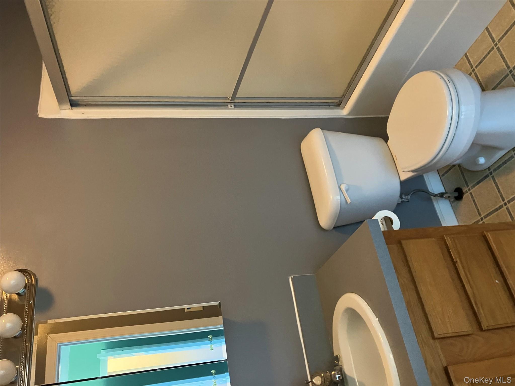 133 Ridgebury Road New Hampton, NY 10958 - Photo 8 of 14 Bathroom featuring light tile patterned floors, vanity, and enclosed tub / shower combo