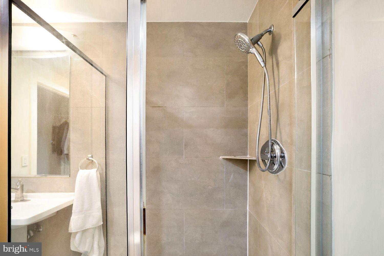 1133 14th Street Northwest, Unit 306 Washington, DC 20005 - Photo 16 of 36 a bathroom with a shower and a tub