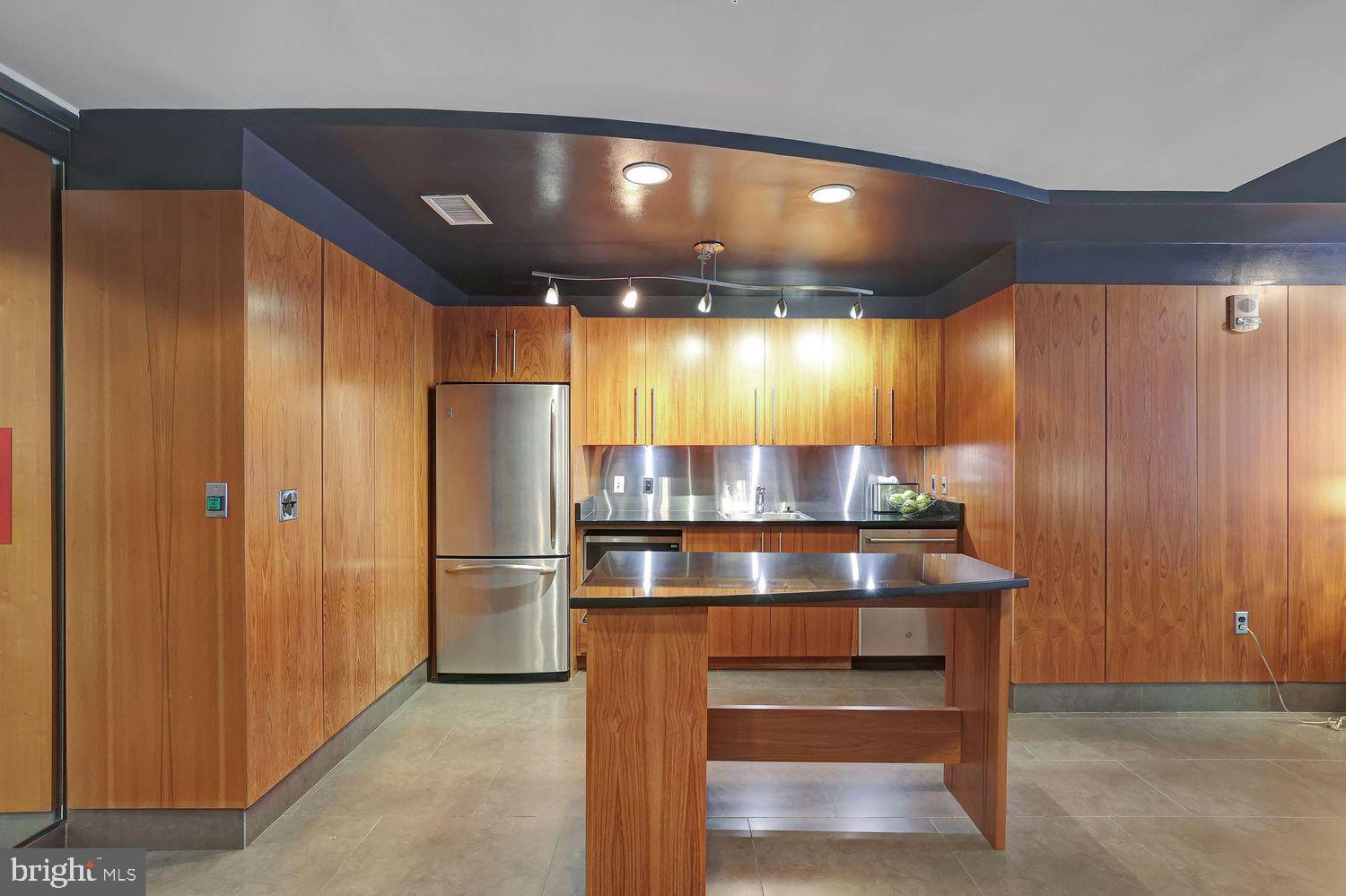 1133 14th Street Northwest, Unit 306 Washington, DC 20005 - Photo 20 of 36 a view of kitchen with a refrigerator and microwave