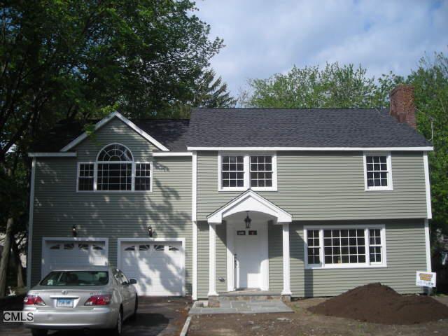 673 Church Hill Road Fairfield, CT 06825 - Photo 1 of 1 a front view of a house with a yard and garage