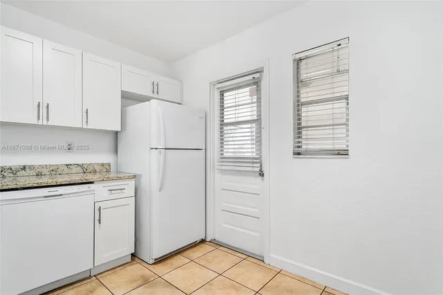 a view of a glass door with a balcony from a window