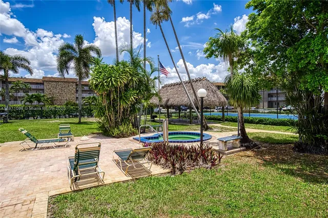 a view of a house with a swimming pool and sitting area