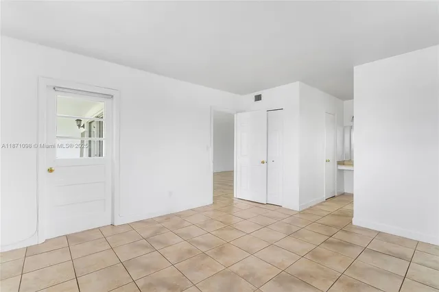 a view of a room with a walk in closet and wooden floor
