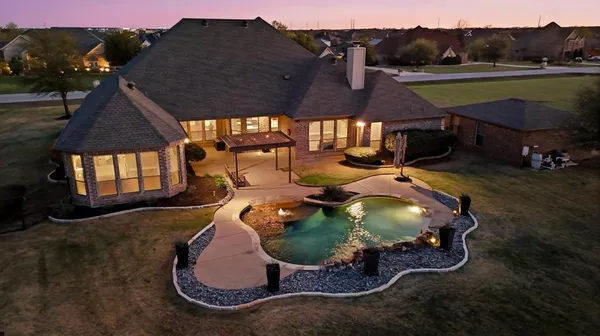 a view of a dining room with furniture a chandelier and wooden floor