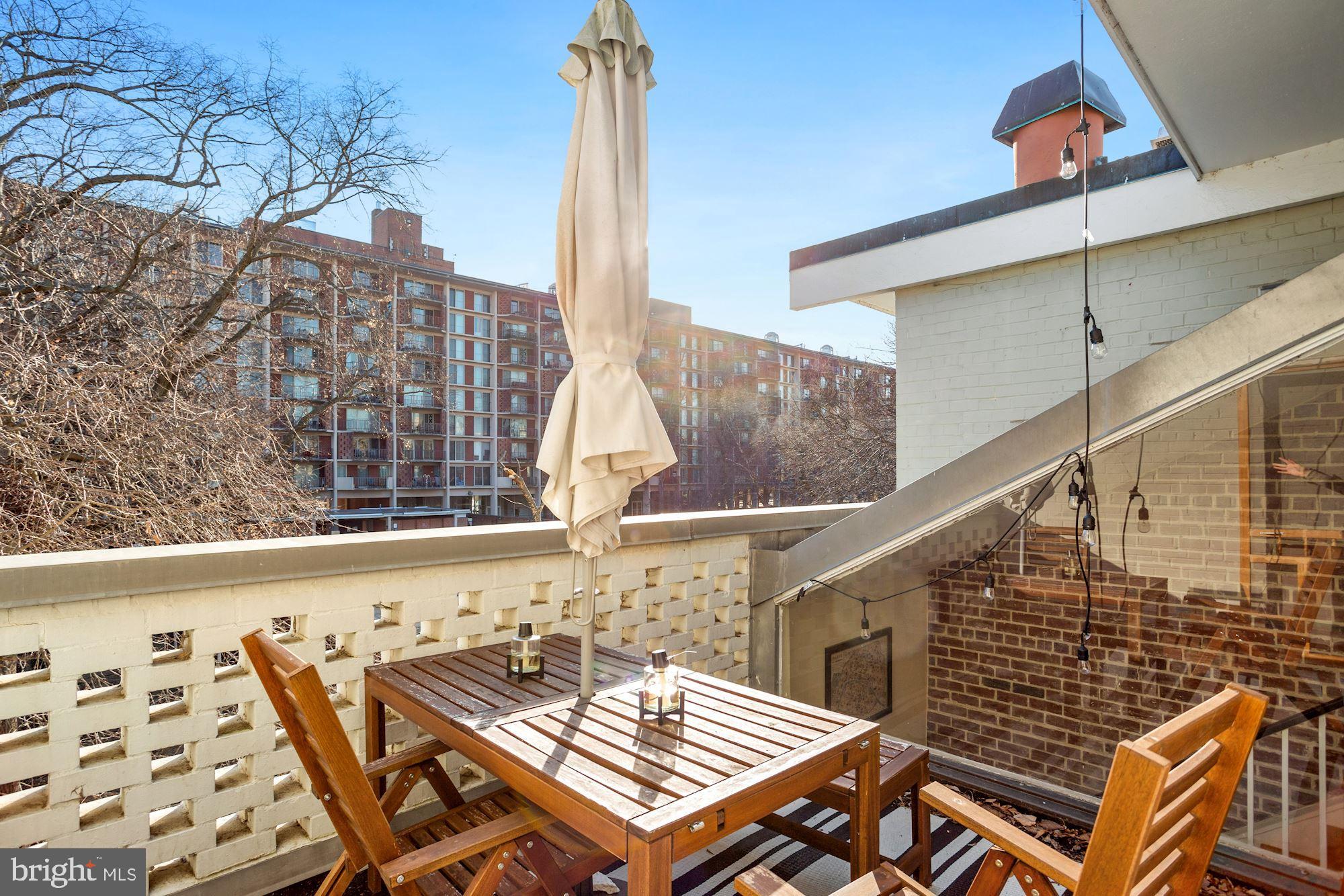 725 Delaware Avenue Southwest, Unit 218 Washington, DC 20024 - Photo 13 of 14 a balcony with table and chairs