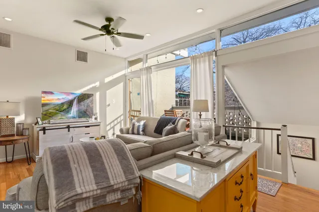a living room with furniture a rug and a chandelier