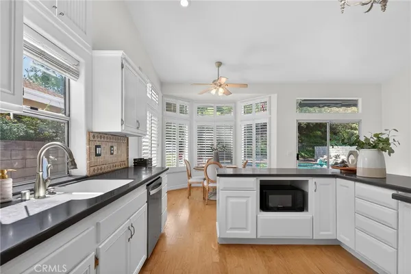 a kitchen with a sink and a stove top oven