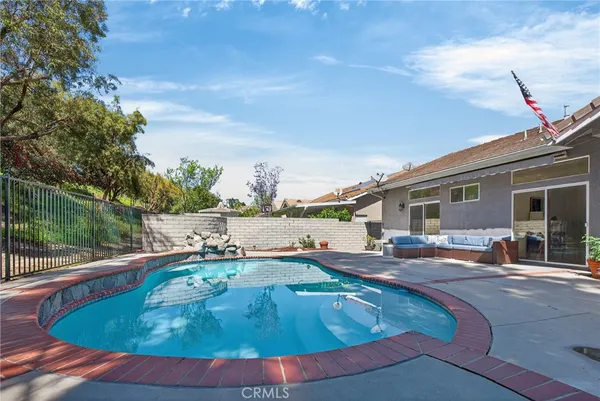 a swimming pool with outdoor seating and yard