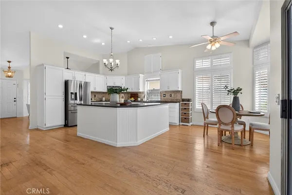 a kitchen with refrigerator cabinets dining table and chairs