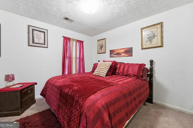 a bedroom with furniture and a book shelf