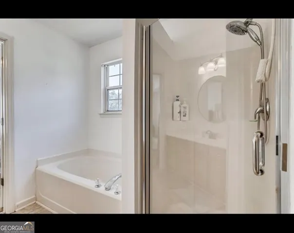 a bedroom with furniture and a flat screen tv