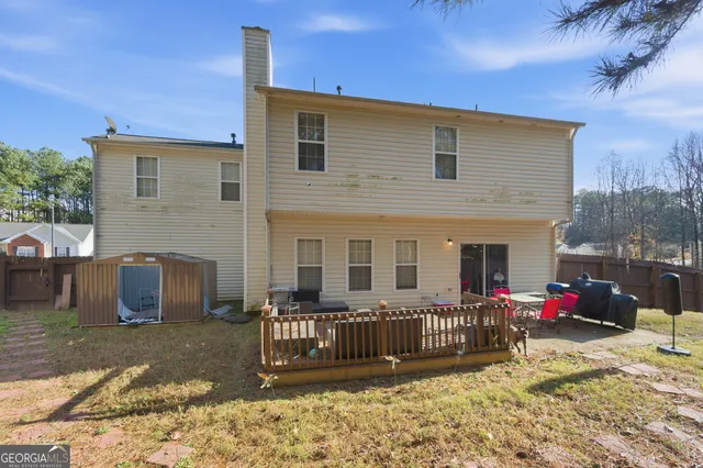 a view of a house with a small yard and furniture