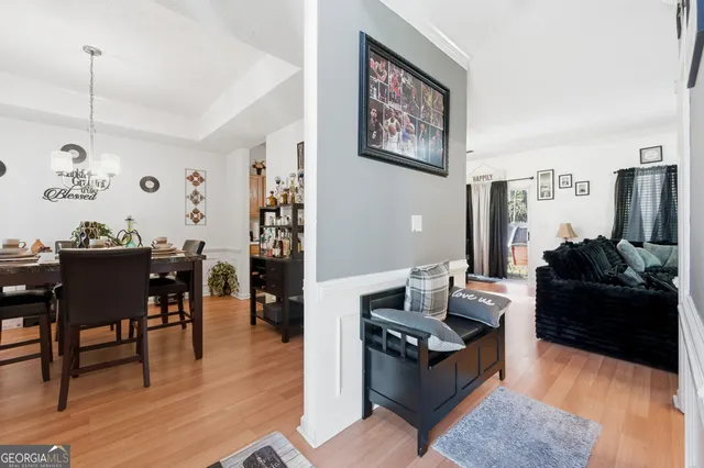 a living room with furniture and wooden floor