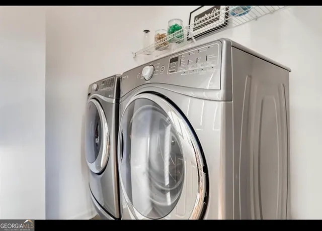 a kitchen with granite countertop stainless steel appliances a refrigerator and a center island