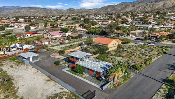 an aerial view of residential houses with outdoor space
