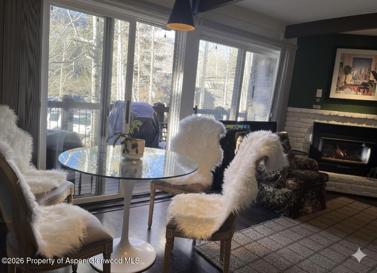 35 Upper Woodbridge Road, Unit 3 Snowmass Village, CO 81615 - Photo 4 of 16 a living room with furniture and a fireplace