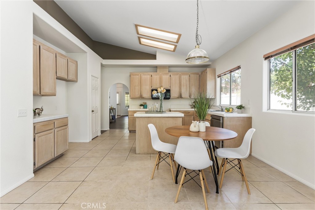 8742 Feathertop Road Riverside, CA 92508 - Photo 18 of 40 The kitchen showcases vaulted ceilings and architectural display ledges above the cabinetry, adding visual interest and opportunities for decorating.Bright, airy & sunny!