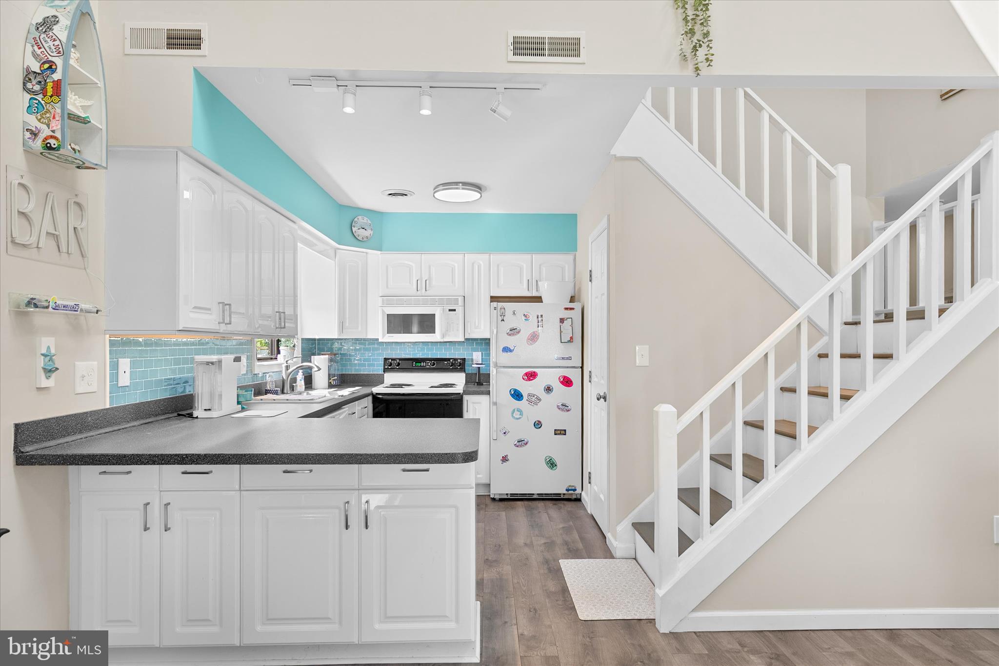 132 Jamestown Road, Unit 601 Ocean City, MD 21842 - Photo 9 of 37 a kitchen with cabinets and white appliances
