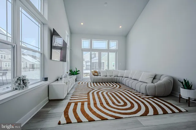 a bedroom with furniture and a large window